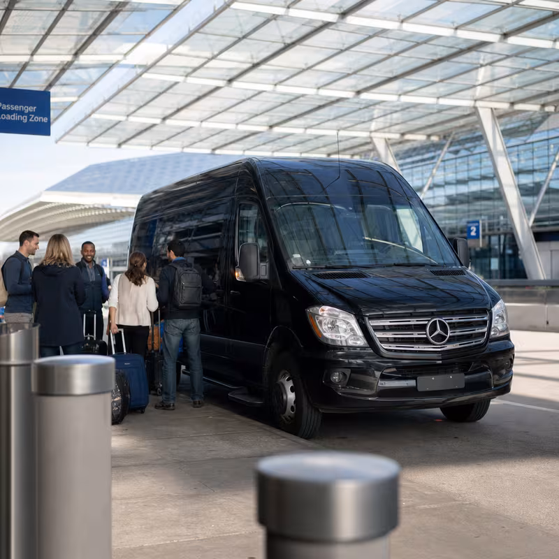 Group boarding a white charter bus for Airport Transportation transportation in Kansas City
