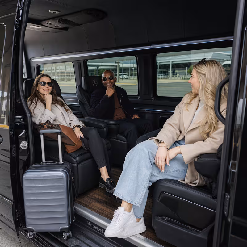 Passengers loading luggage while boarding an Kansas City group shuttle