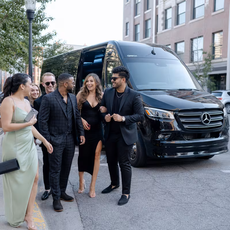 Group boarding a white charter bus for Bachelor & Bachelorette Transportation transportation in Kansas City