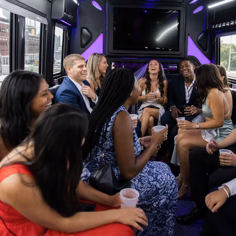 Party bus interior with wraparound leather seating and LED lighting in Kansas City
