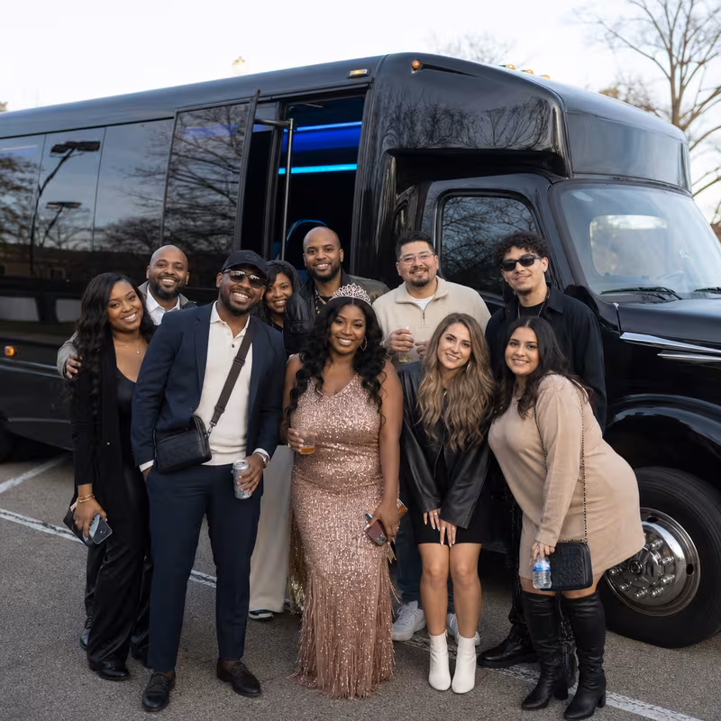 Group boarding a white charter bus for Birthday Transportation transportation in Kansas City