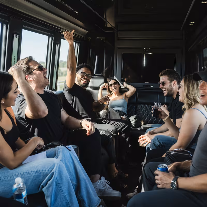 Group boarding a white charter bus for Concert Transportation transportation in Kansas City