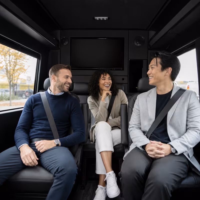 Group boarding a white charter bus for Corporate Transportation transportation in Kansas City