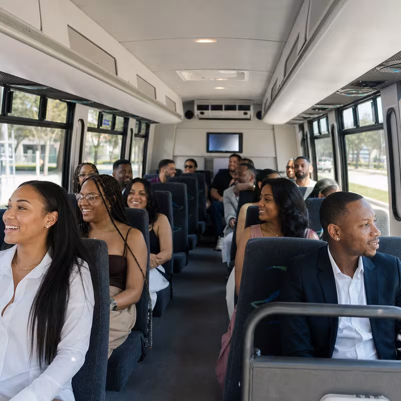 Group boarding a white charter bus for Private Event Transportation transportation in Kansas City