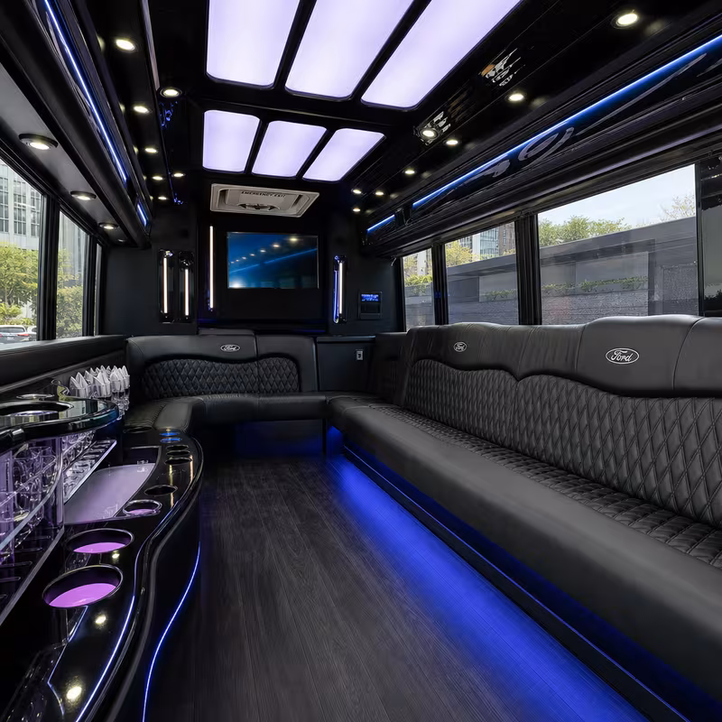 Party bus interior with wraparound leather seating and LED lighting in Kansas City