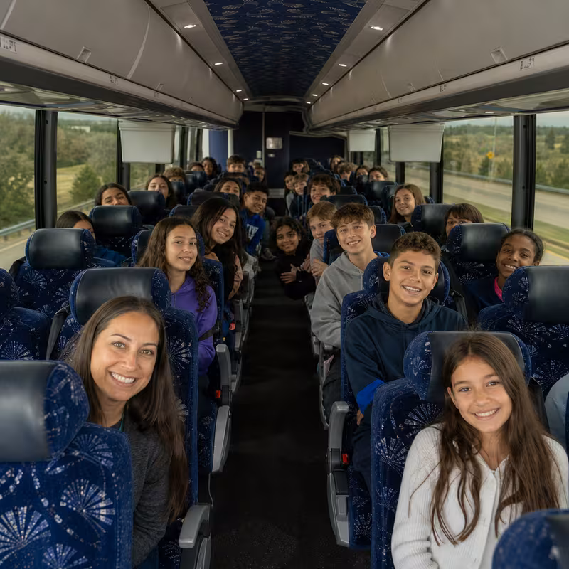 Group boarding a white charter bus for School Transportation transportation in Kansas City