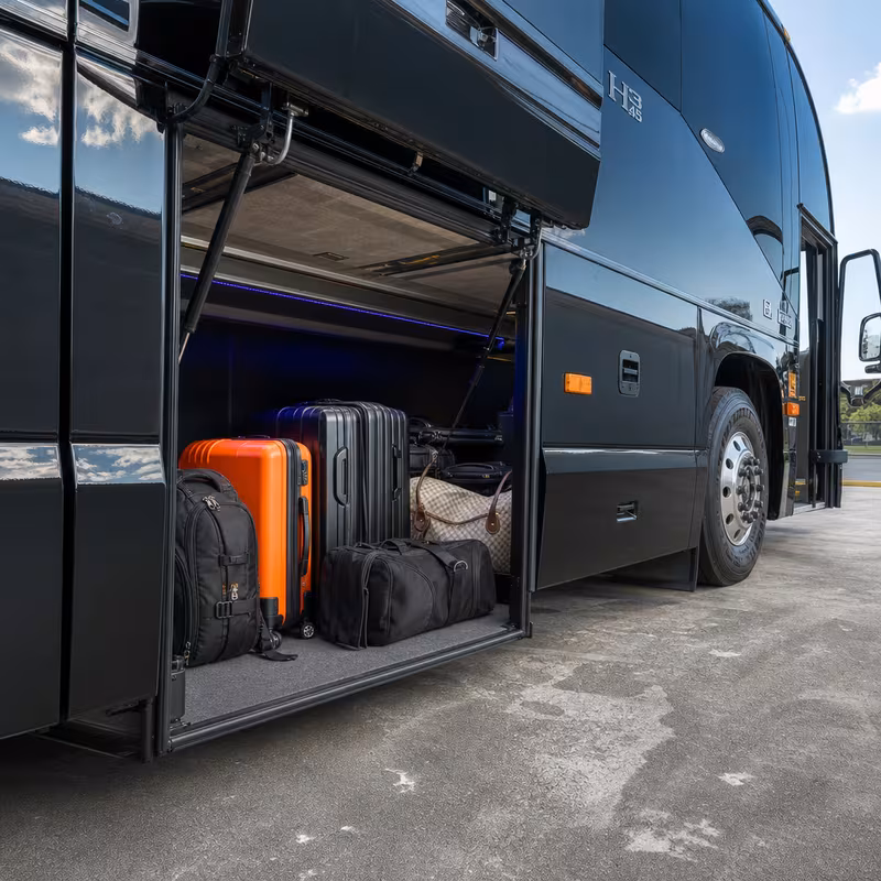 Party bus interior with wraparound leather seating and LED lighting in Kansas City