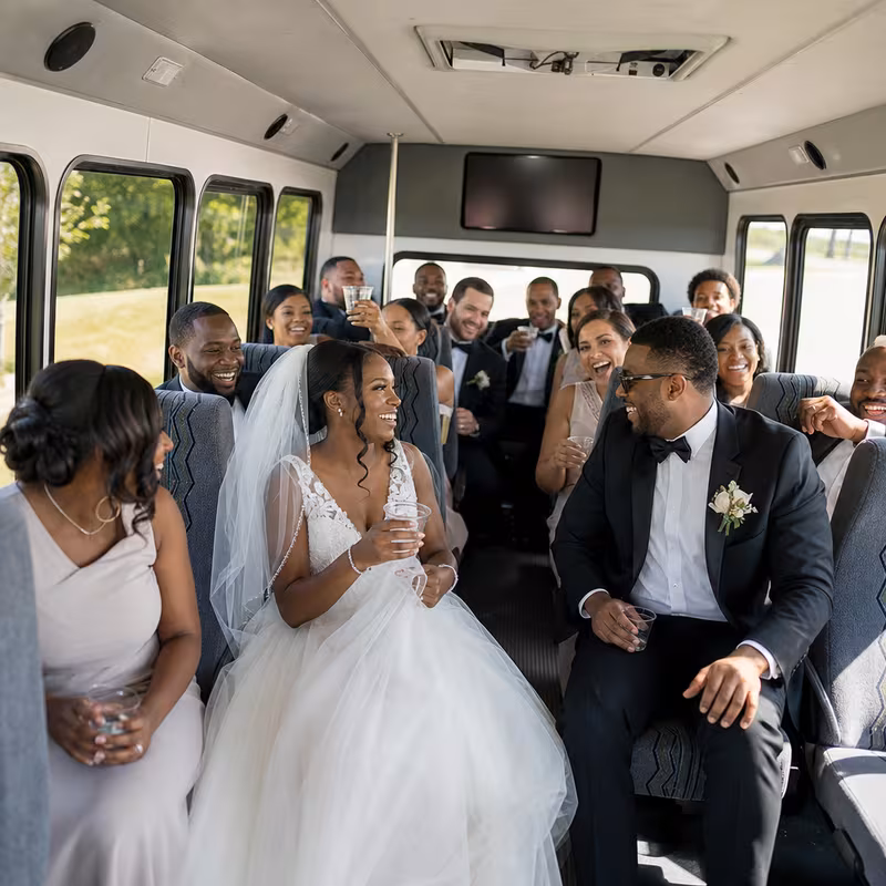 Group boarding a white charter bus for Wedding Transportation transportation in Kansas City